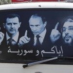 A poster showing Syrian President Assad, Russian President Putin and Lebanese Hezbollah leader Nasrallah is seen on a micro bus in al-Qardahah town, near Latakia city